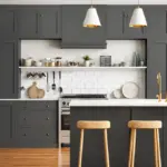 Charcoal grey shaker kitchen with white island bench, wooden bar stools and brushed brass hardware in an Australian Hampton's style home