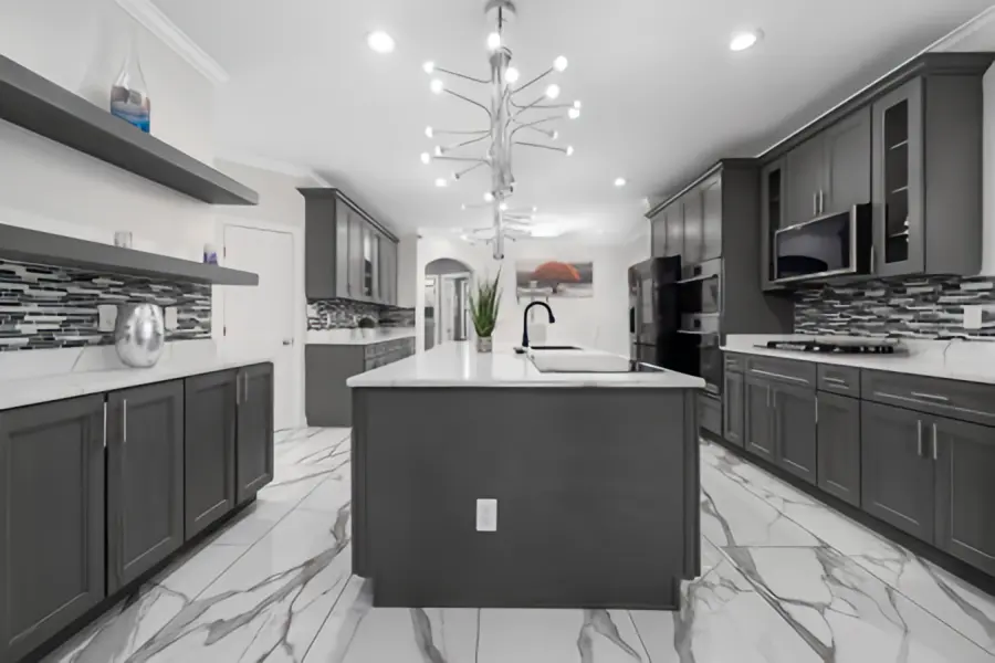 Modern American-style kitchen with grey shaker kitchen cabinetry, large white marble island bench and chrome chandelier