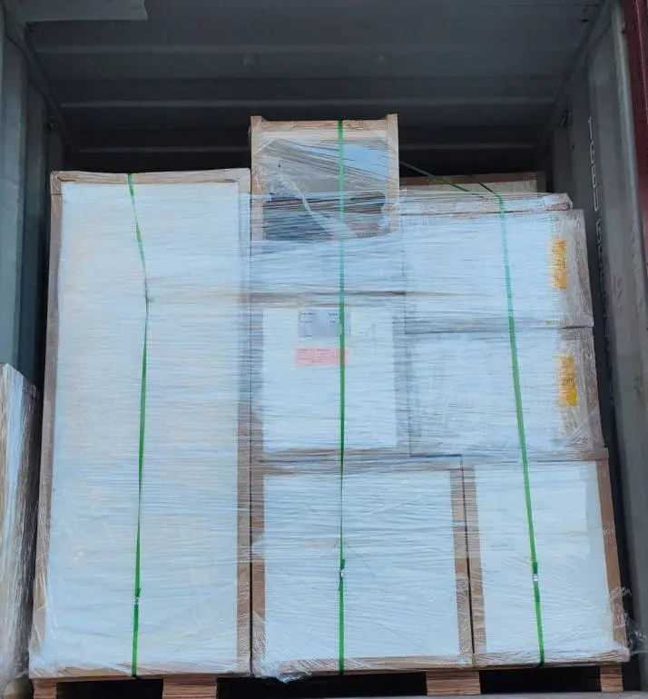 Cabinetry pallets strapped and shrink-wrapped inside a shipping container, ready for export to Australia